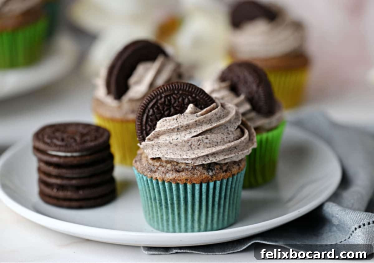 A single cupcake topped with generous Oreo Buttercream Frosting and a mini Oreo cookie, ready to be enjoyed.