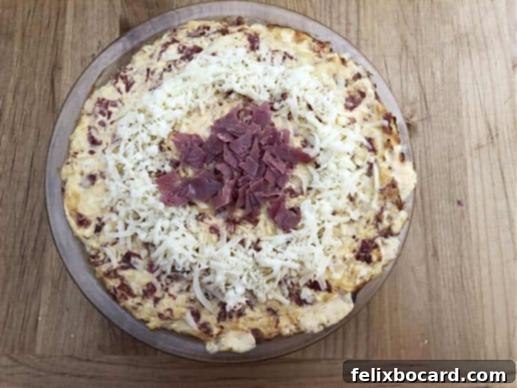 Reuben dip with additional Swiss cheese and chopped corned beef added on top