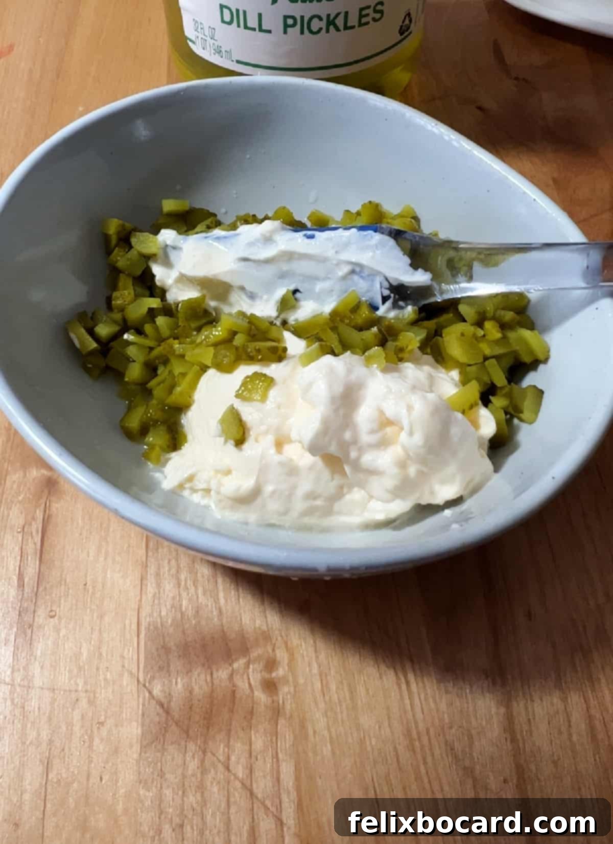 bowl with mayo and chopped pickles ready to mix.