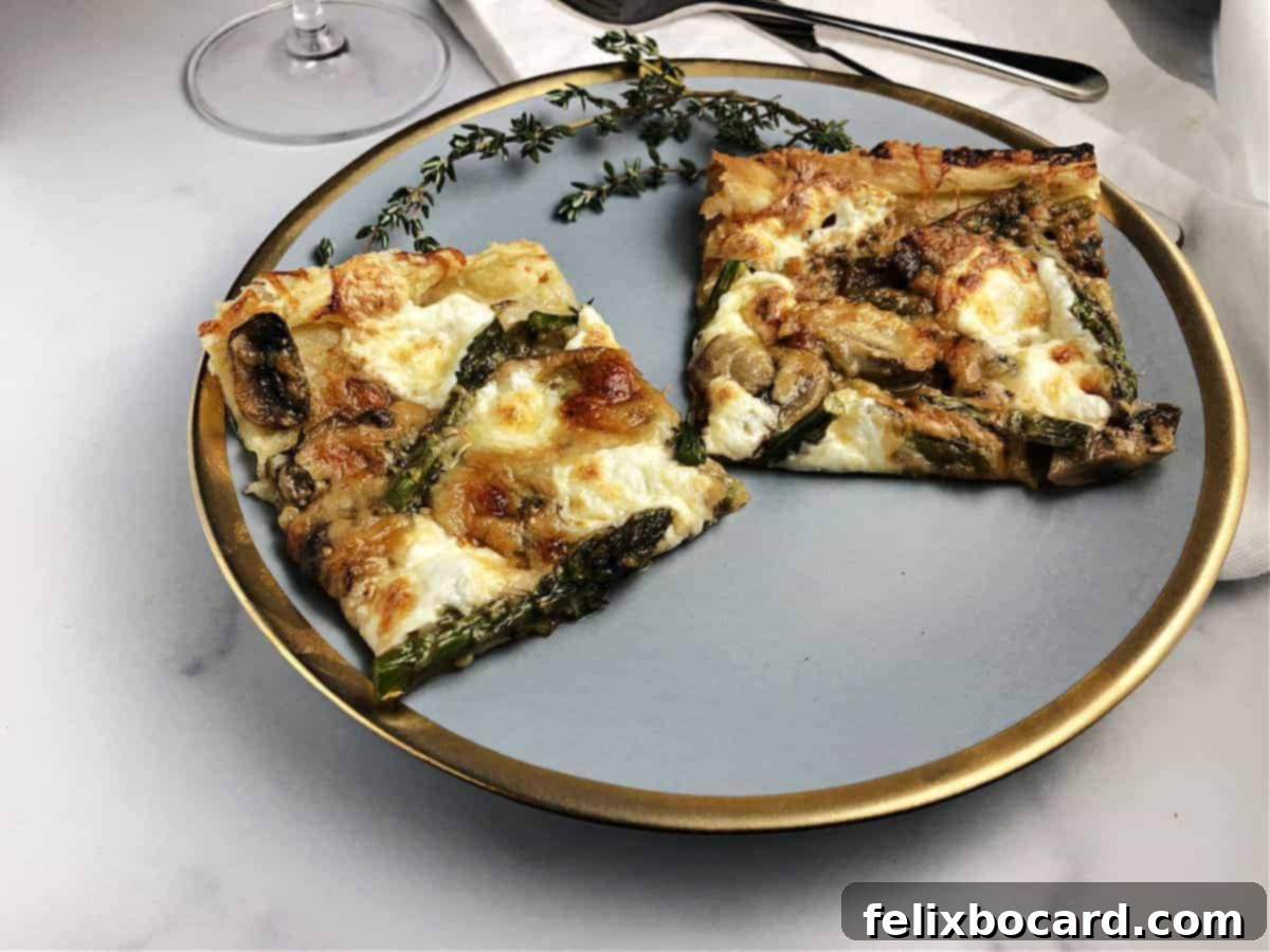 Golden brown puff pastry galette with asparagus and mushrooms, served on a small plate