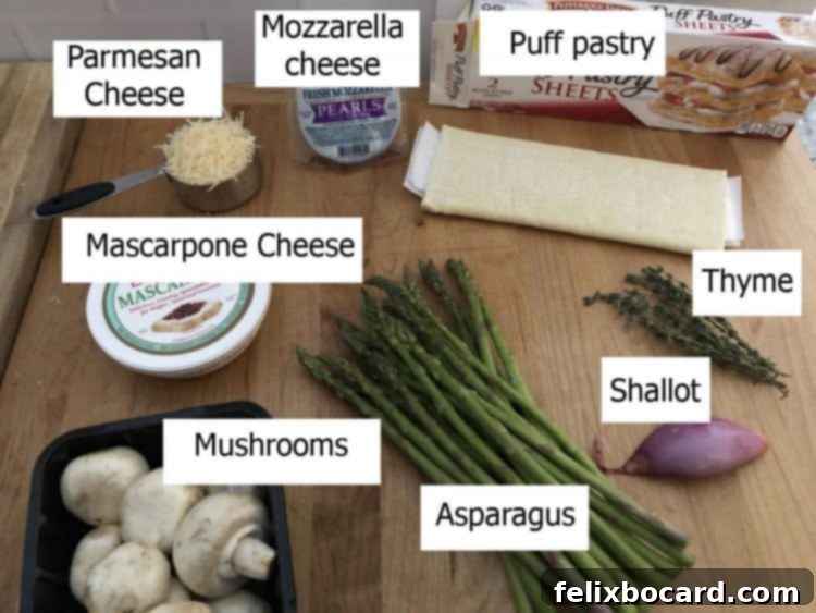 A collection of fresh ingredients laid out on a table, including asparagus, mushrooms, shallots, and various cheeses, ready for making a galette