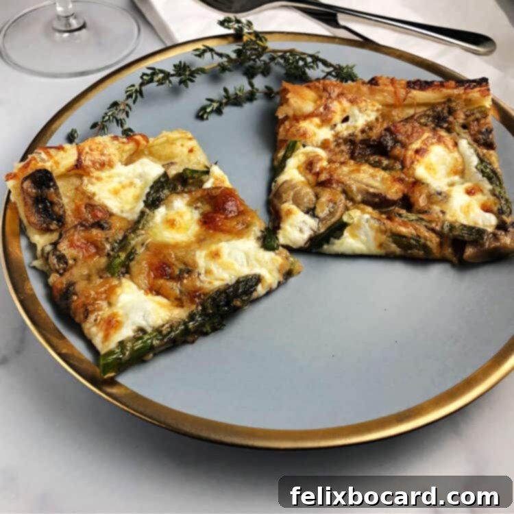 Two slices of asparagus and mushroom puff pastry galette on a gold-rimmed plate, showcasing the flaky crust and vibrant filling