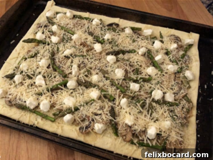 Galette with all filling components, topped with an even sprinkle of Parmesan cheese