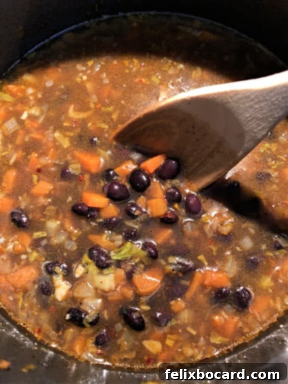 Soup ingredients, including onions, carrots, and celery, are shown starting to cook in a pot, releasing their aromas.