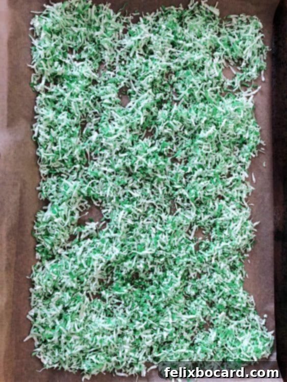 tinted coconut spread out on a baking sheet