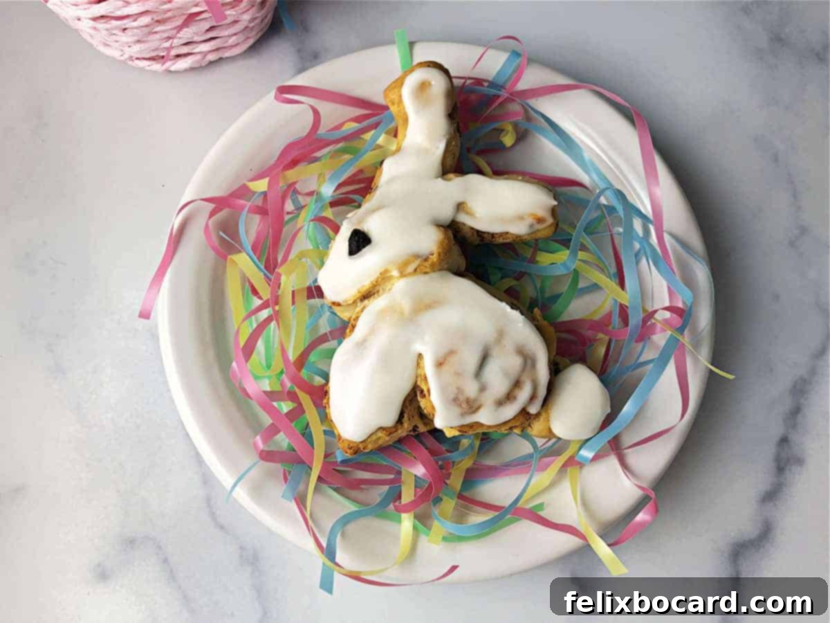 Easter bunny cinnamon roll on a white plate with pastel pretend grass