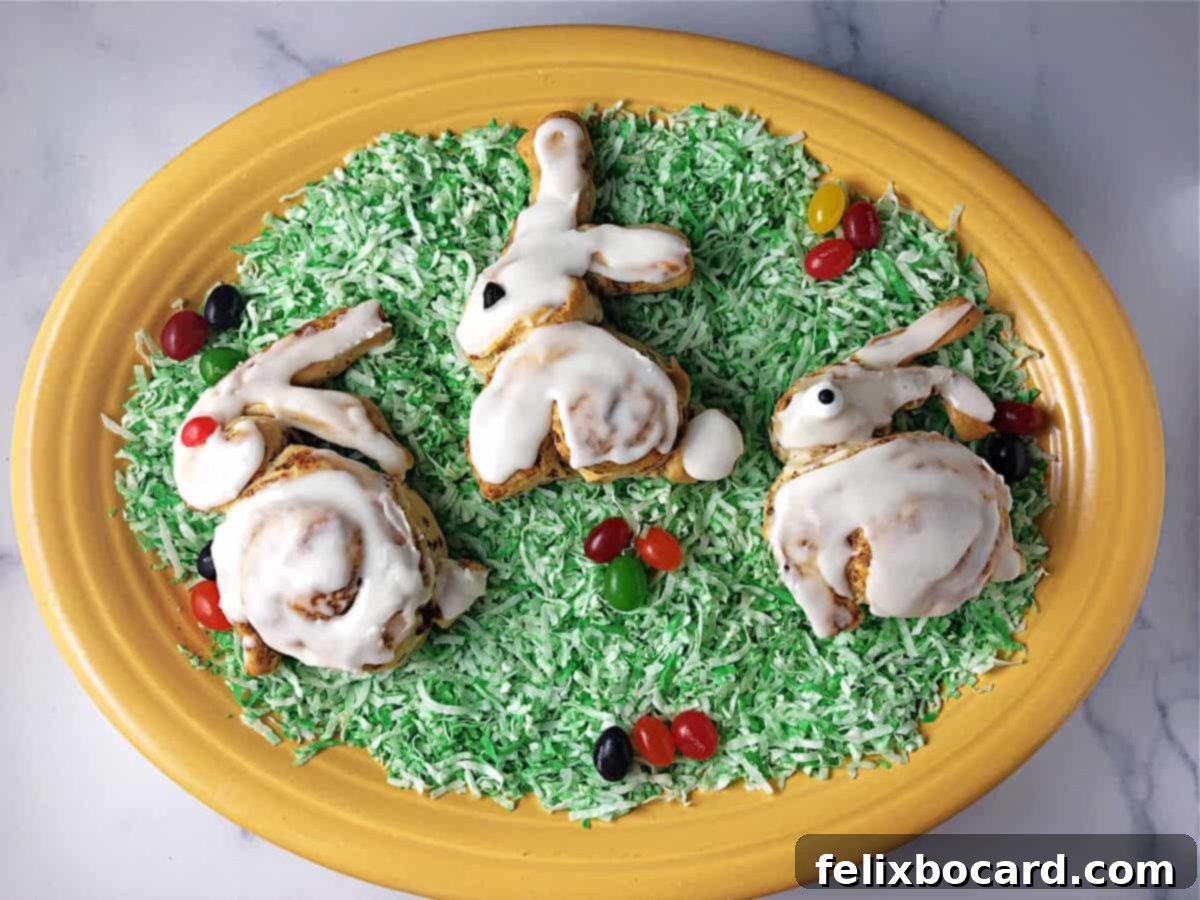 3 bunny shaped cinnamon rolls on a platter of green colored "grass".