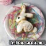 Easter bunny cinnamon roll on a white plate with pastel pretend grass