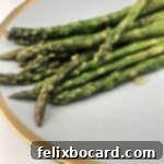 pan fried asparagus on a gold rimmed plate