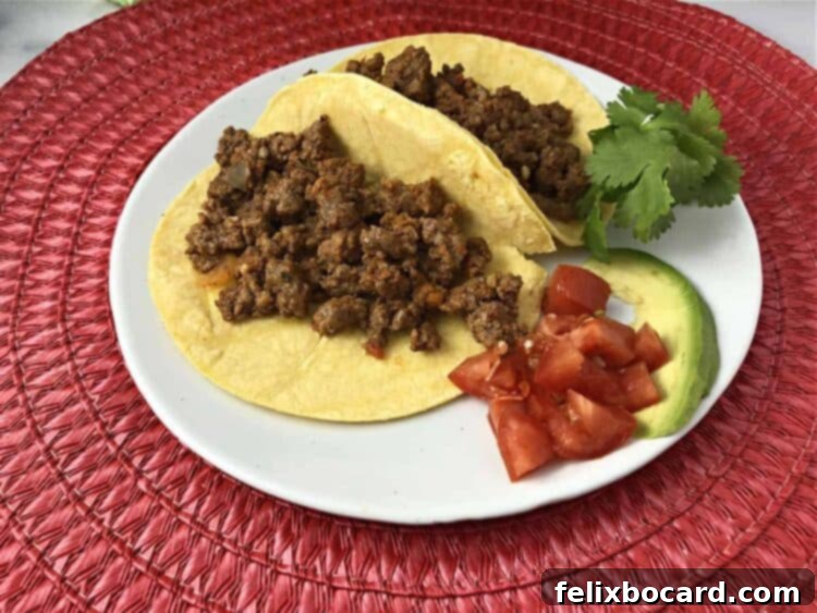 Delicious taco meat served in small corn tortillas on a plate, ready for a taco night feast.