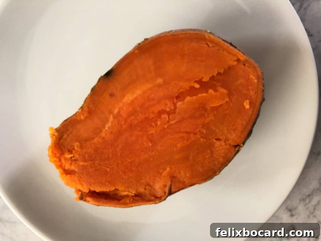 Sweet Potato Boats Made Easy 4 Halved sweet potato showing its soft, fluffy interior, ready for stuffing.
