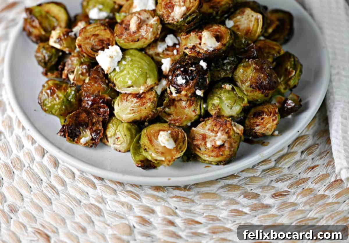 Roasted Brussels Sprouts with Tangy Goat Cheese and Balsamic Glaze 2 Roasted Brussels sprouts with goat cheese and balsamic vinegar, ready to eat.