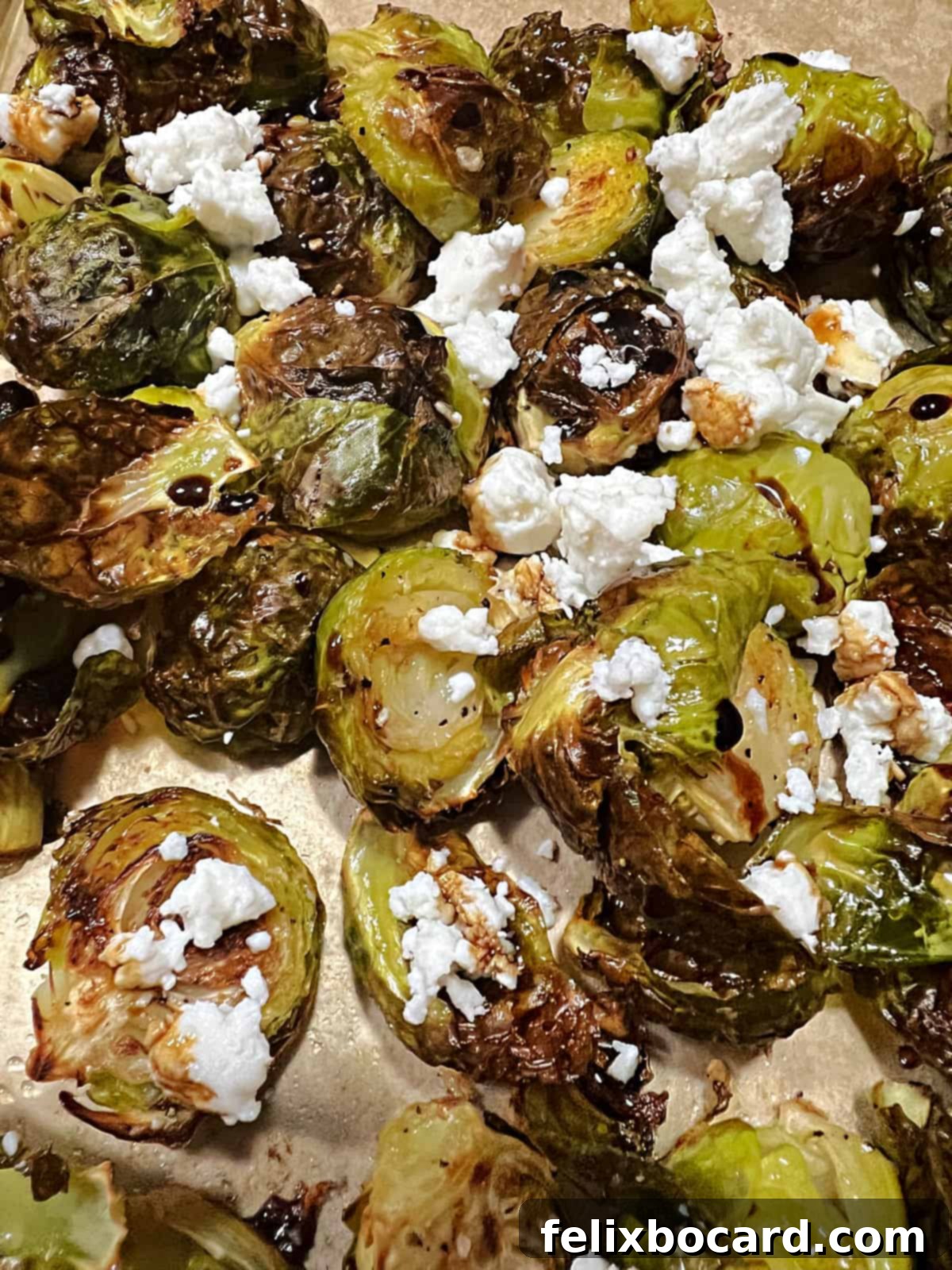 Roasted Brussels Sprouts with Tangy Goat Cheese and Balsamic Glaze 10 Close up of roasted Brussels sprouts with goat cheese and balsamic.
