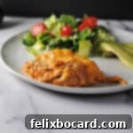 keto chicken taco casserole on a plate with salad