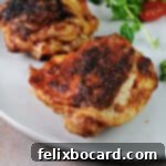 Air fried chicken thigh on a plate.