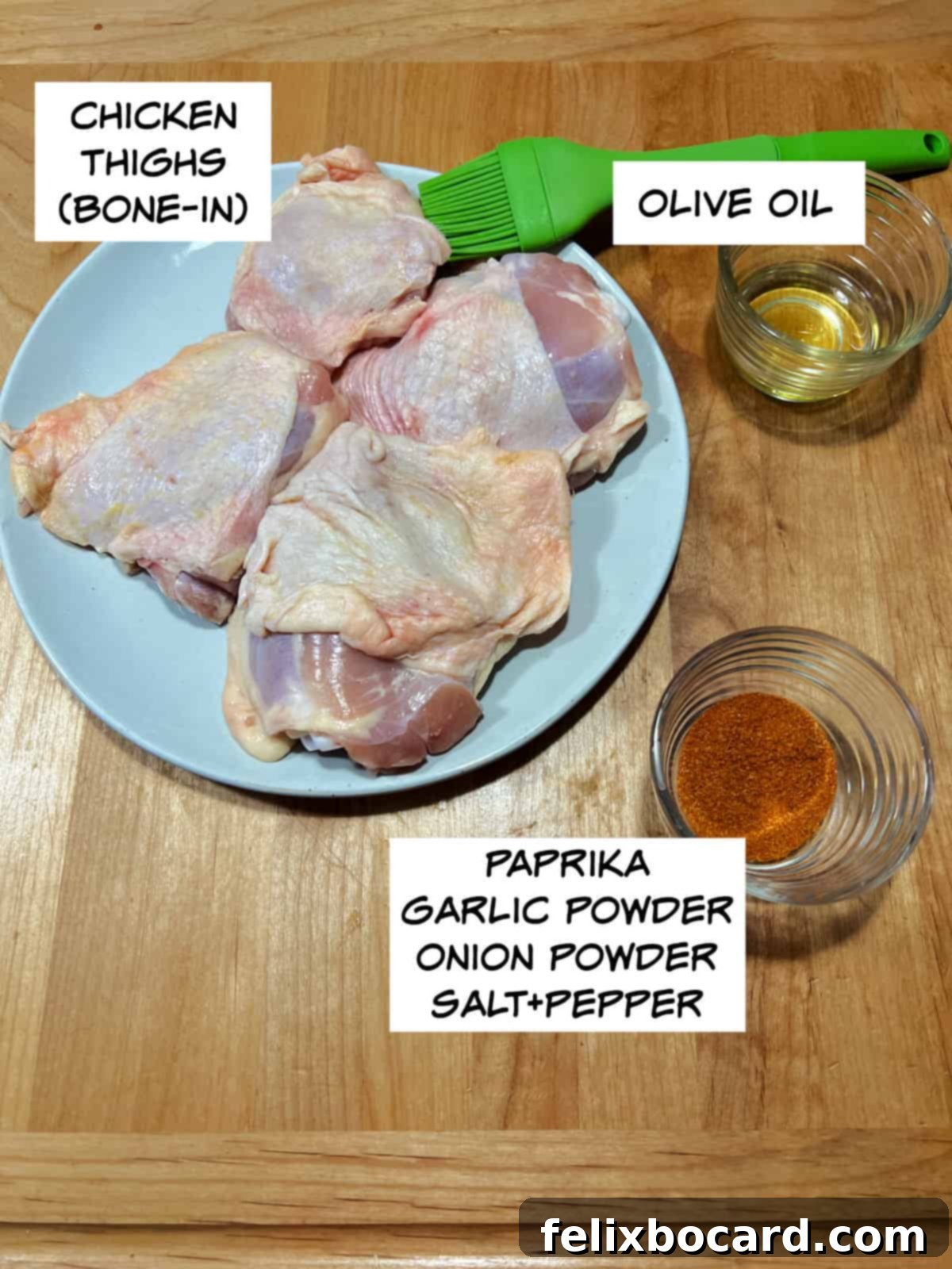 Close-up of ingredients for air fryer chicken thighs: raw chicken thighs, a bottle of olive oil, and a small bowl of mixed spices.