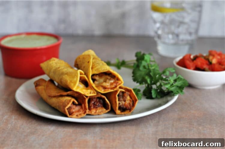 A serving of air fried taquitos on a small plate, garnished with fresh cilantro, with various dipping sauces in the background.