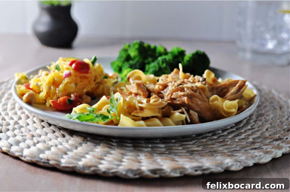 Instant Pot French onion chicken on noodles, broccoli and salad behind on the same plate