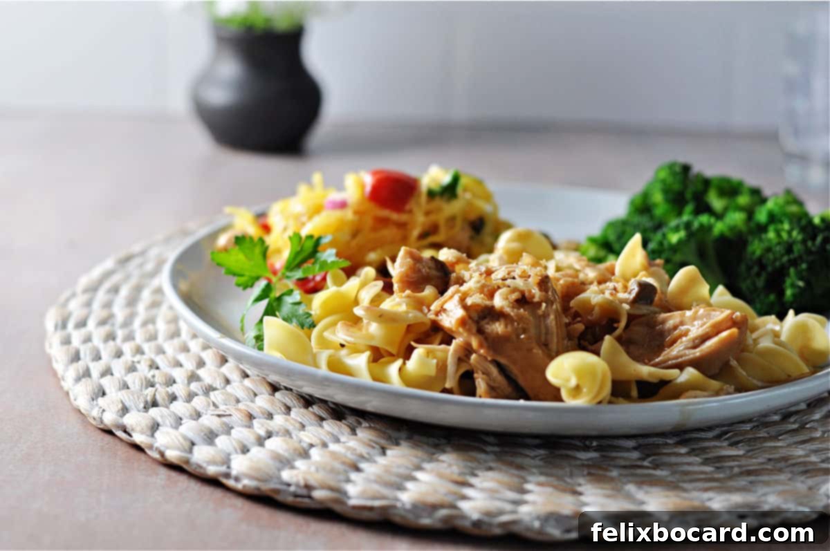 Instant pot French onion chicken served on noodles.