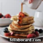 Oat Milk Pancakes stack with syrup pouring on top