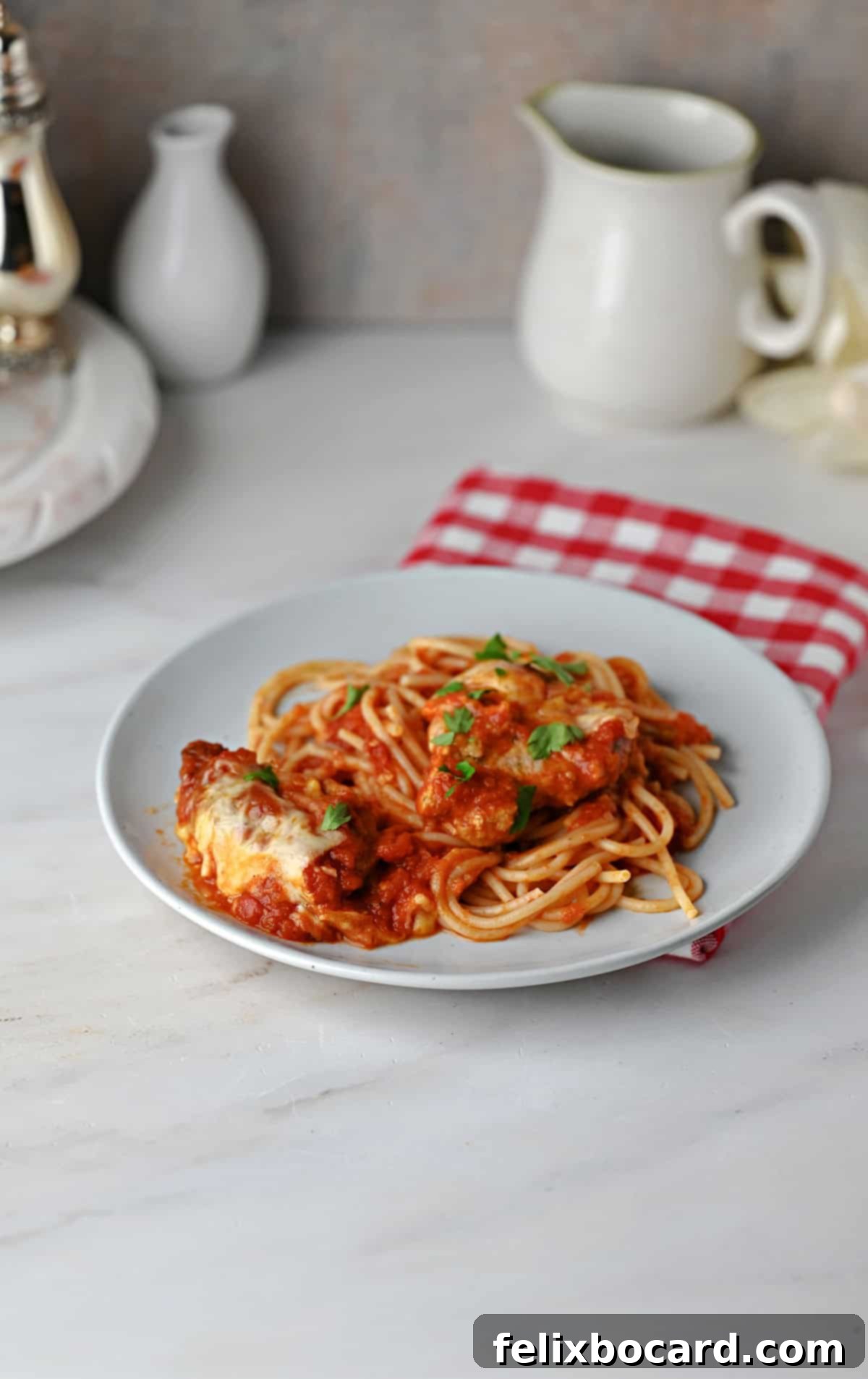 Pork Parmesan and sauce served on spaghetti noodles.